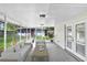 Staged screened patio with couch, chairs, and coffee table overlooking backyard at 223 Pinehurst Dr, Auburndale, FL 33823