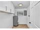 Clean utility room with water heater, wood-look floor, and a window at 223 Pinehurst Dr, Auburndale, FL 33823