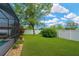 Beautifully landscaped backyard with a mature tree, green lawn, and white privacy fence at 2973 Blackwater Creek Dr, Lakeland, FL 33810