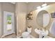 Charming bathroom with vanity sink, toilet, and shower and patio access, providing convenience and style at 2973 Blackwater Creek Dr, Lakeland, FL 33810