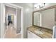 Well-lit bathroom featuring granite countertop vanity, wood framed mirror and access to hallway at 2973 Blackwater Creek Dr, Lakeland, FL 33810