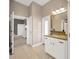 Well-lit bathroom featuring granite countertop vanity, tiled floor and access to other rooms at 2973 Blackwater Creek Dr, Lakeland, FL 33810