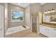 Bathroom with jacuzzi tub, shower, and granite topped vanity providing a spa-like retreat at 2973 Blackwater Creek Dr, Lakeland, FL 33810
