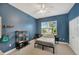 Bright bedroom with blue walls, ceiling fan and view to the exterior through window at 2973 Blackwater Creek Dr, Lakeland, FL 33810