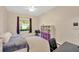 Comfortable bedroom with large window, desk, shelving, and a cozy reading corner with a hanging chair at 2973 Blackwater Creek Dr, Lakeland, FL 33810