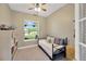 Cozy bedroom features a twin-sized daybed, a window, neutral paint, and a ceiling fan at 2973 Blackwater Creek Dr, Lakeland, FL 33810
