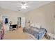 Bright bedroom featuring neutral walls, ceiling fan, and cozy daybed, perfect for relaxation and study at 2973 Blackwater Creek Dr, Lakeland, FL 33810