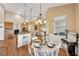 Open concept dining area showcases natural light, stylish chandelier, and seamless flow to the kitchen at 2973 Blackwater Creek Dr, Lakeland, FL 33810