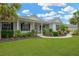 Charming home with a covered front porch, black shutters, and beautiful landscaping at 2973 Blackwater Creek Dr, Lakeland, FL 33810