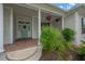 Charming covered front porch featuring classic white columns and colorful hanging flower baskets at 2973 Blackwater Creek Dr, Lakeland, FL 33810