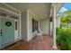 Inviting front porch with brick flooring, rocking chairs, and a beautifully decorated front door at 2973 Blackwater Creek Dr, Lakeland, FL 33810