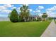 Well-maintained front yard with lush green lawn, mature trees, and a sidewalk at 2973 Blackwater Creek Dr, Lakeland, FL 33810