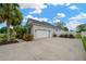Home with a two car garage, long driveway, and beautiful green space and landscaping at 2973 Blackwater Creek Dr, Lakeland, FL 33810