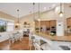 Bright kitchen with breakfast bar, pendant lighting, and stainless appliances overlooking the dining area at 2973 Blackwater Creek Dr, Lakeland, FL 33810