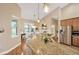 Bright kitchen with breakfast bar, pendant lighting, and stainless appliances, overlooks pool at 2973 Blackwater Creek Dr, Lakeland, FL 33810