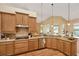 Updated kitchen with granite countertops, wood cabinets, and a stainless steel dishwasher at 2973 Blackwater Creek Dr, Lakeland, FL 33810
