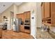 Well-equipped kitchen with stainless steel appliances, wooden cabinets, and an eat-in pantry at 2973 Blackwater Creek Dr, Lakeland, FL 33810