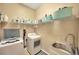 Bright laundry room with washer, dryer, utility sink, and plentiful shelving at 2973 Blackwater Creek Dr, Lakeland, FL 33810