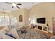 Bright and airy living room featuring hardwood floors, a large sectional sofa, and a media center at 2973 Blackwater Creek Dr, Lakeland, FL 33810