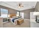 Serene main bedroom with tray ceilings, neutral tones, and a cozy seating area by the window at 2973 Blackwater Creek Dr, Lakeland, FL 33810