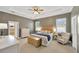 Spacious main bedroom featuring a tray ceiling, soft lighting, and access to the ensuite bathroom at 2973 Blackwater Creek Dr, Lakeland, FL 33810