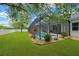 Backyard view of pool area with screened enclosure, landscaping, and well-maintained lawn at 2973 Blackwater Creek Dr, Lakeland, FL 33810