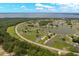 Scenic aerial view of a condo community nestled amidst lush greenery, featuring a serene lake backdrop at 4209 Club Cir, Lakeshore, FL 33854