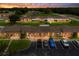 Stunning twilight aerial view of a condo community, enhanced by landscaped grounds and inviting illumination at 4209 Club Cir, Lakeshore, FL 33854