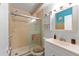 Cozy bathroom featuring a glass door shower, vanity with storage, and ocean-themed decor at 4209 Club Cir, Lakeshore, FL 33854