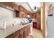 Galley kitchen with granite counters, wood cabinetry, and stainless steel appliances at 4209 Club Cir, Lakeshore, FL 33854
