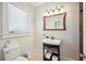 Bathroom with vanity, framed mirror, and toilet with window view at 739 Park Hill Ave, Lakeland, FL 33801