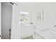 Bright bathroom with a shower, modern vanity, marble countertop, and a window providing natural light at 739 Park Hill Ave, Lakeland, FL 33801