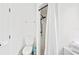 Bright white bathroom featuring a toilet, shower with black fixtures, and modern towel rack at 739 Park Hill Ave, Lakeland, FL 33801