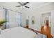 Bright bedroom with wood floors, neutral walls, and updated ceiling fan with lights at 739 Park Hill Ave, Lakeland, FL 33801