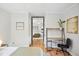 Bright bedroom with wood floors, a mirrored closet, and a stylish desk area, offering a comfortable retreat at 739 Park Hill Ave, Lakeland, FL 33801