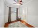 Bright bedroom featuring hardwood floors, a ceiling fan and neutral color palette at 739 Park Hill Ave, Lakeland, FL 33801