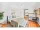 Sunlit bedroom featuring hardwood floors, a bed, a workspace, and a large mirrored closet at 739 Park Hill Ave, Lakeland, FL 33801