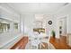 Bright dining room featuring a modern chandelier, wood floors, and a white round table at 739 Park Hill Ave, Lakeland, FL 33801