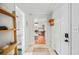 Bright entryway with wood shelves and access to the living area and bathroom at 739 Park Hill Ave, Lakeland, FL 33801