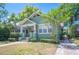 Charming home showcasing lush landscaping, a covered porch, and inviting curb appeal at 739 Park Hill Ave, Lakeland, FL 33801
