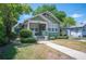 Charming home featuring lush landscaping, a covered porch, and inviting curb appeal at 739 Park Hill Ave, Lakeland, FL 33801