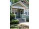 Charming home exterior with a welcoming front porch and well-maintained landscaping at 739 Park Hill Ave, Lakeland, FL 33801