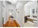 Hallway featuring polished wood floors leading to bedrooms and a bathroom at 739 Park Hill Ave, Lakeland, FL 33801