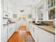 Bright kitchen with white appliances and cabinetry, opening to the dining area at 739 Park Hill Ave, Lakeland, FL 33801
