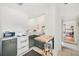 Open kitchenette with breakfast bar, stainless appliances, and neutral countertops at 739 Park Hill Ave, Lakeland, FL 33801