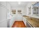 Bright laundry room featuring a washer, dryer, granite countertops, and storage cabinets at 739 Park Hill Ave, Lakeland, FL 33801