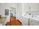 Laundry room with washer, dryer, cabinets and granite countertop with view to dining room at 739 Park Hill Ave, Lakeland, FL 33801