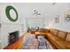 Open living room with hardwood floors, fireplace, and a comfortable leather sectional at 739 Park Hill Ave, Lakeland, FL 33801