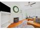 Bright living room featuring hardwood floors, a decorative fireplace, and built-in shelving at 739 Park Hill Ave, Lakeland, FL 33801