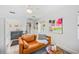 Comfortable living room with sofa, rug, kitchenette and bright art at 739 Park Hill Ave, Lakeland, FL 33801